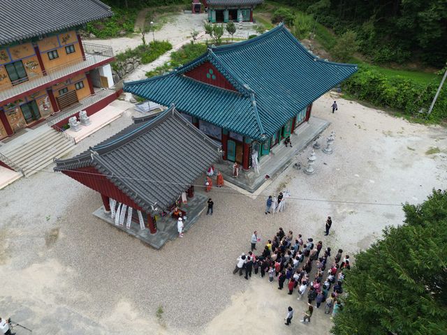 마당에 모인 대중과 법당 항공 사진